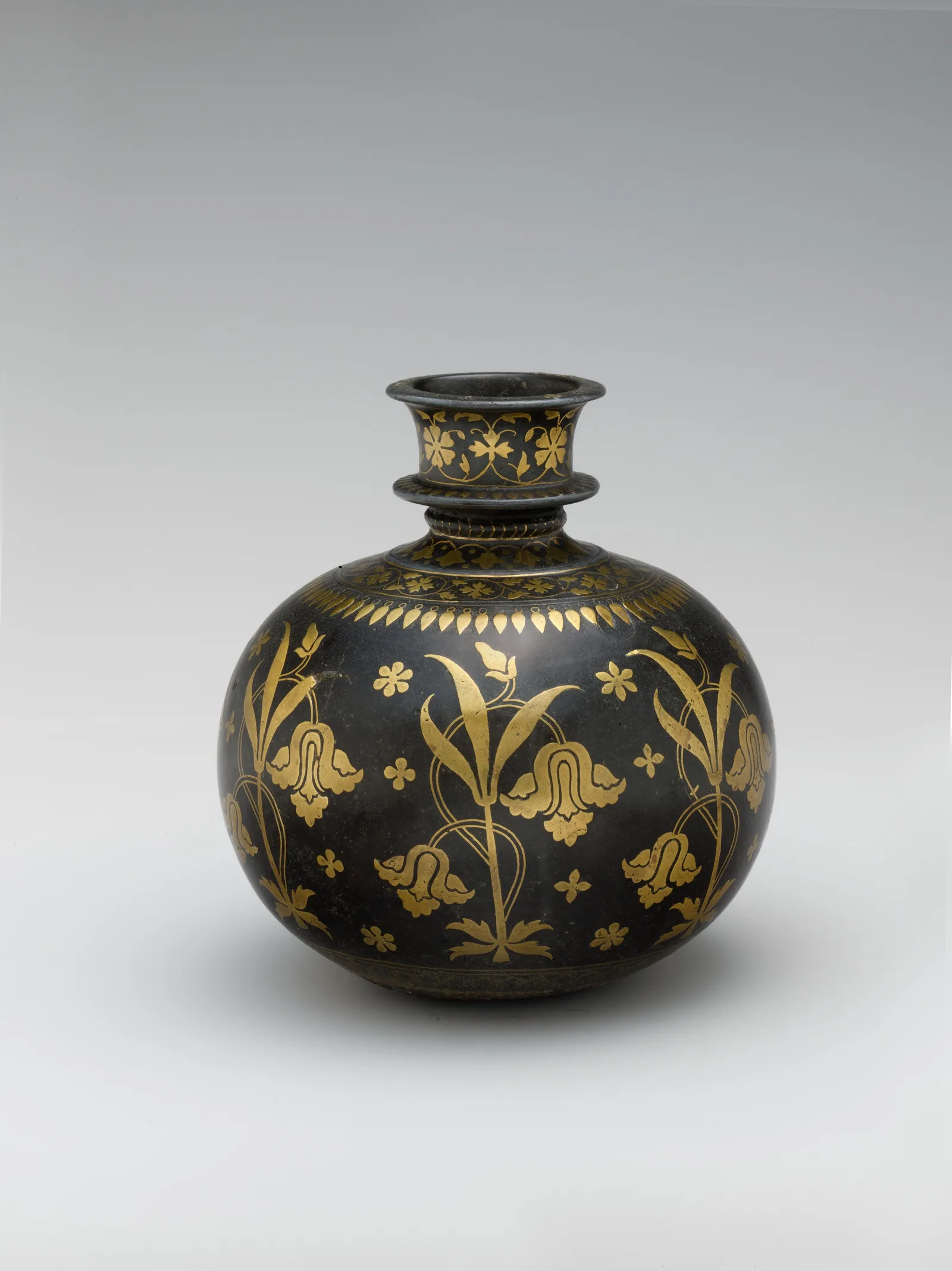 Dark bidriware huqqa base with polished metallic floral inlay of irises on a blackened ground.